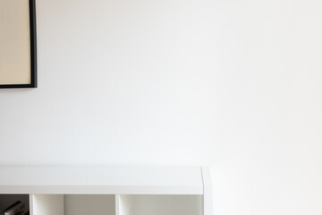 Minimal white wall mockup. Modern interior with empty shelf and frame, living room