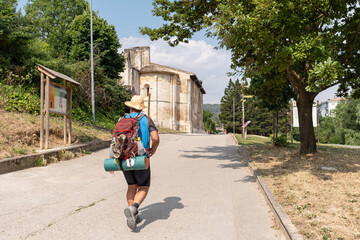 Way of St. James. Pilgrim next to the Church of the Holy Sepulchre in Estella
