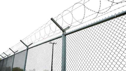 Chain link fence with barbed wire top isolated on a white background PNG. AI GENERATED.