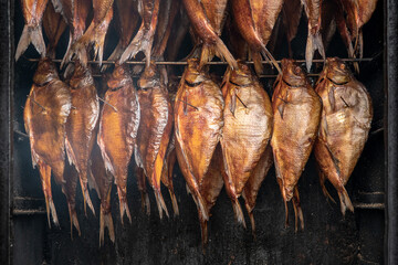 Smoking fish in a smokehouse. Smoked bream fish
