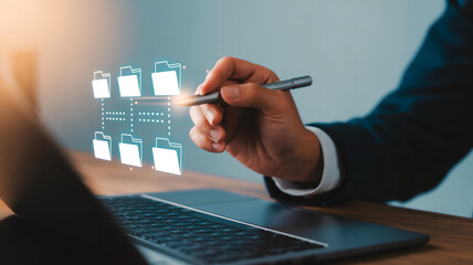 A digital illustration shows a hand with stylus interacting with floating white folder icons on a dark laptop against a blurred blue-gray background