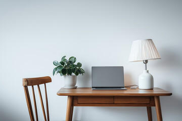 minimalist home office setup, wooden desk with sleek laptop, small potted plant, modern desk lamp, clean white wall background, natural lighting, Scandinavian style