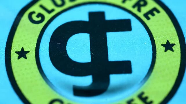 Close-up of a blue circular badge with yellow border and black symbol
