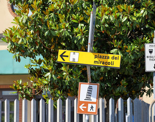 Piazza dei Miracoli (Square of Miracles) street sign on a a crooked post in Pisa, Italy. Leaning...