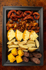 Traditional Colombian food platter (Picada or Fritanga) with chorizo, morcilla, chicharron, corn,...