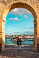 Girl exploring the historic alleyways of Valletta, Malta