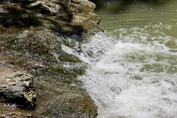 A close view of the water flowing over the rocks in the creek.