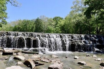 The flowing waterfall on a sunny day.