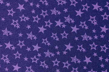 
Texture of paper with stars. Decorative sheet of cardboard with stars. Lilac background with stars