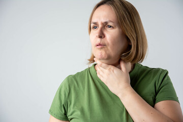 Sick woman with sore throat coughing and feeling unwell, holding neck in pain, health problem,...