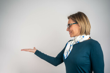 Confident businesswoman pointing at blank copy space with both hands, advertising concept with...