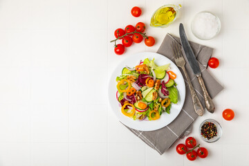 Cucumber salad on a wooden background.Homemade salad with fresh vegetables, cucumber, tomato, sweet...