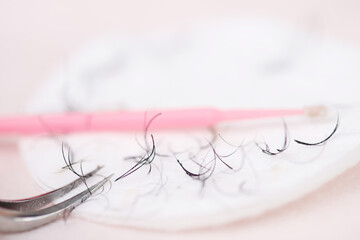 Eyelash removal tools on cotton pad for beauty procedures