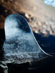 Macro view of a uniquely shaped ice stalagmite inside the Felsőforrás Cave. The translucent ice...