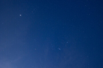 Night sky with stars and planetary light in deep blue