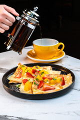 Fruit Crepe with Lemon Sauce and Berries, Served with Hot Tea Being Poured by Hand