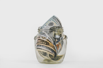 Small Retirement Savings: Jar with US Dollar Banknotes for Future.