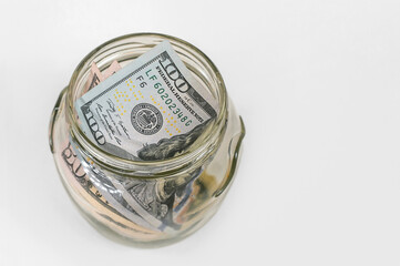 Top-Down View: US Dollars in a Clear Savings Jar