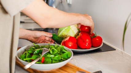  Boy choosing fresh vegetables to prepare vegetarian salad, healthy eating of teenager