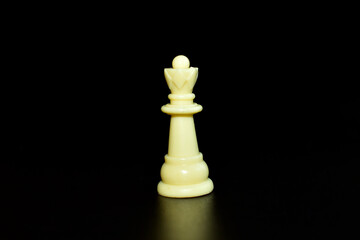 Chess piece queen, white on black background.