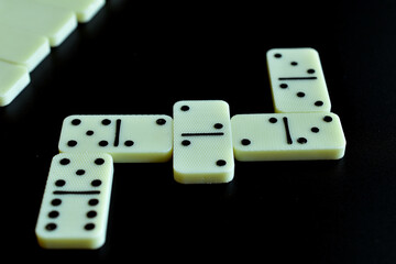 Domino board game. The dice on the table create an abstract figure.