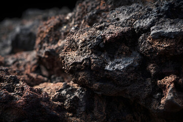 Volcanic Rock Formation: Close-up of porous, dark, and textured rock surface.