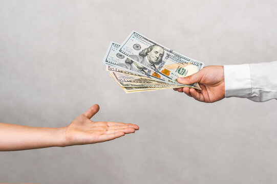 Enterprising Kids: Child Transferring Dollar Banknotes for Business.