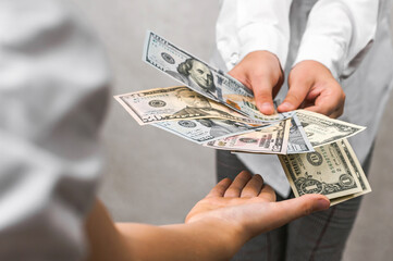 Child's Reward: Hands Receiving Dollars for Work or Chores.
