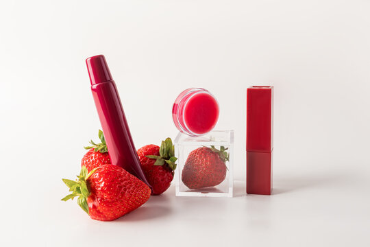 Elegant strawberry-themed cosmetic products on white