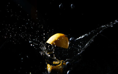 Dynamic splash of lemon half and blueberries in dark water with droplets suspended in air, vibrant...