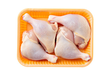 Raw chicken legs packaged in orange plastic tray on meat poultry