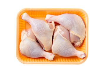 Raw chicken legs packaged in orange plastic tray on meat poultry