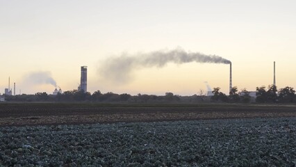 Heavy gray smoke is poured from the chimney pipes of thermal power plant. Carbon dioxide emitting...
