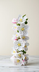 Stacked apple blossom flowers against a neutral background