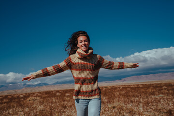 Young woman running on mountains background, camera angle view