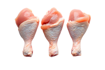 Three raw chicken drumsticks with skin and bone exposed on meat poultry