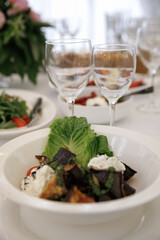 A beautifully arranged table with vibrant flowers and a selection of fresh fruits accompanied by...