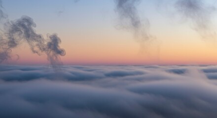 Aerial view of sunrise over a thick layer of clouds, with smoke plumes rising above