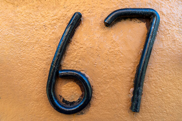 Close-Up of Metallic Numbers Against a Vibrant Textured Surface