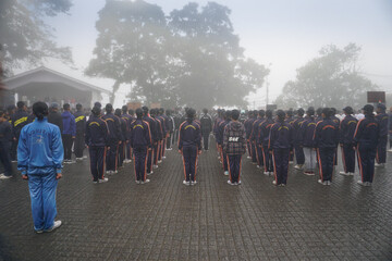 Darjeeling,West Bengal,India -11.08.2023: Girls Military training in foggy morning, School student...