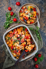Homemade italian baked cheesy mezze maniche Pasta alla norma with eggplant, olives and tomatos...