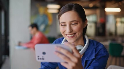 Freelancer watching video mobile phone sitting restaurant closeup. Smiling woman - Powered by Adobe