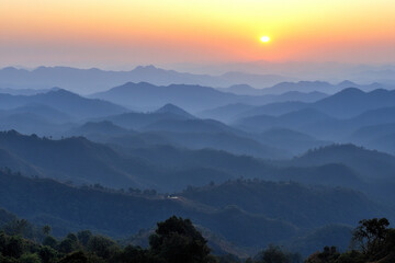 Majestic mountain range illuminated by dawn's early light