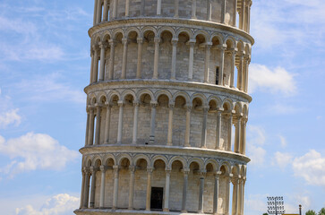 Close-up view of the leaning tower of Pisa in Pisa, Italy. Marble arches and columns.