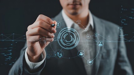 A businessman is planning a strategy, using a pen to draw a circle diagram on a digital interface showing a network of connections