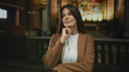 Woman thinking in a church setting, showcasing contemplation under dim lighting in a spiritual...