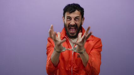 Hispanic man in prison jumpsuit passionately gestures in handcuffs against a purple backdrop,...