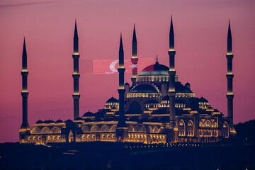 Çamlıca Mosque Illuminated at Sunset During Ramadan. A breathtaking view of a grand mosque,...
