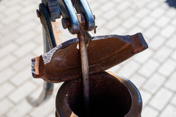 Antique water pump still in use in some areas today, isolated on white background.
hand-operated...