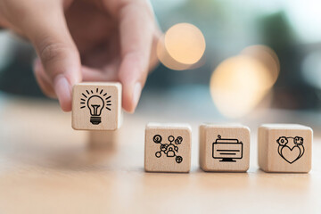 Design Thinking Process Concept – Wooden Blocks Displaying Icons Representing Key Stages of a Solution-Focused, Problem-Solving Methodology for Innovation and Strategic Development.
